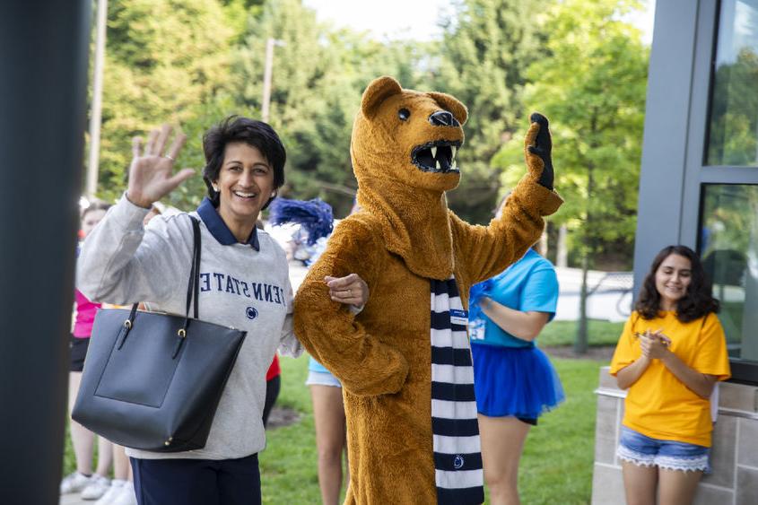 Nittany Lion mascot, left, waves to the crowd with Chancellor Pyati, right